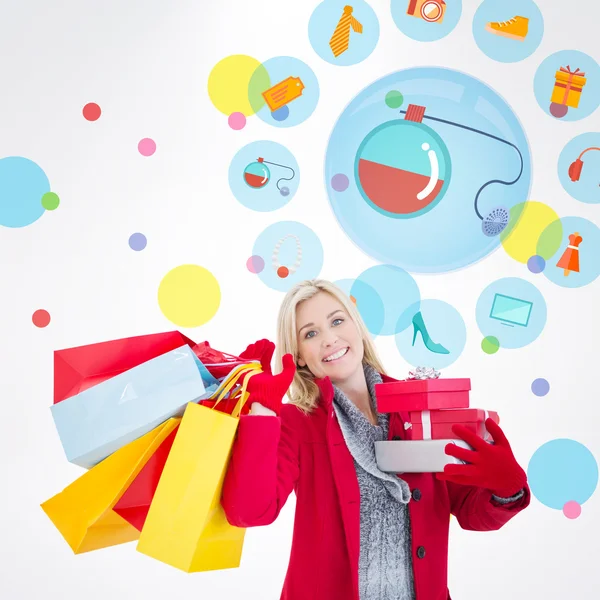 Festive blonde holding many gifts — Stock Photo, Image