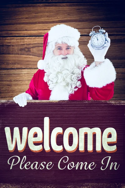 Santa holding alarm clock and sign — Stock Photo, Image