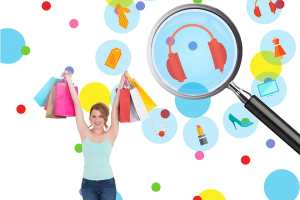 Blonde holding up shopping bags — Stock Photo, Image