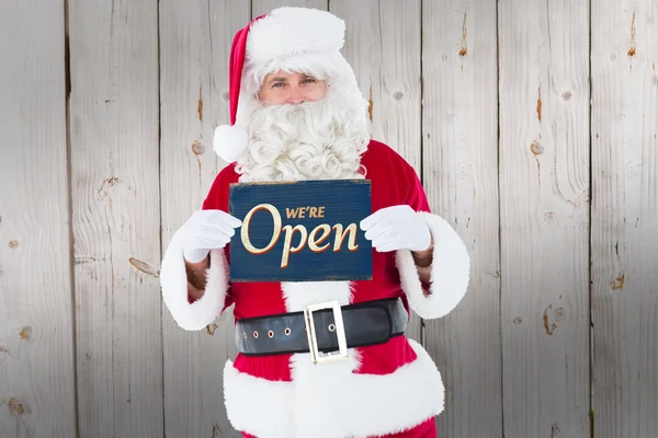 Sourire santa claus holding page — Photo