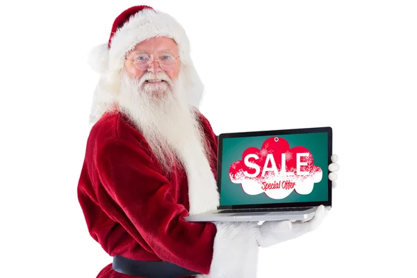 Santa Claus presents a laptop — Stock Photo, Image