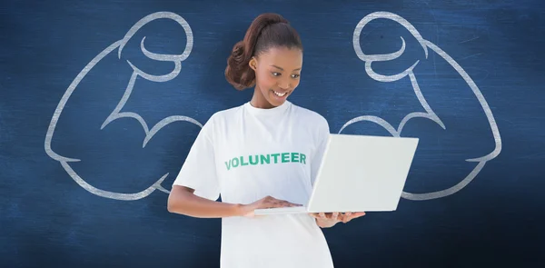 Happy volunteer using laptop — Stock Photo, Image