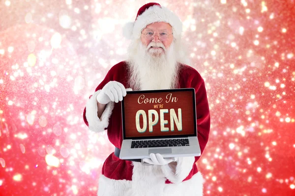 Imagem composta de santa claus apresenta um laptop — Fotografia de Stock