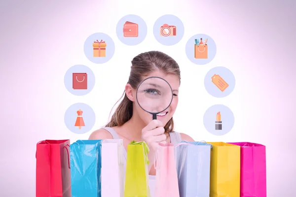 Woman looking through a magnifying glass — Stock Photo, Image