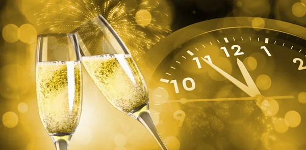 Composite image of champagne glasses clinking — Stock Photo, Image