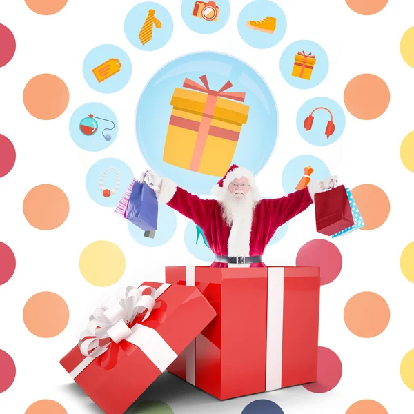 Composite image of santa standing in large gift — Stock Photo, Image