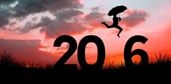 Composite image of woman jumping with umbrella — Stock Photo, Image