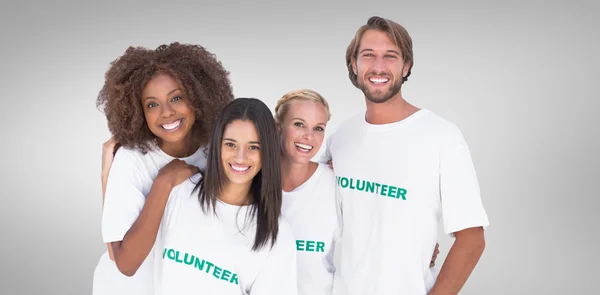 Složený obraz usmívající se skupina dobrovolníků — Stock fotografie