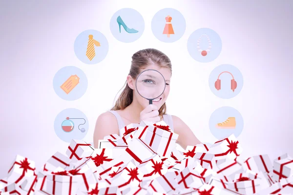 Woman looking through a magnifying glass — Stock Photo, Image