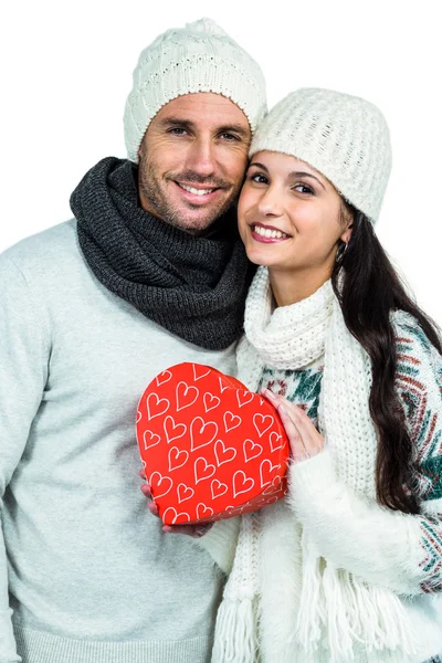 Smiling couple holding gift box — Stock Photo, Image