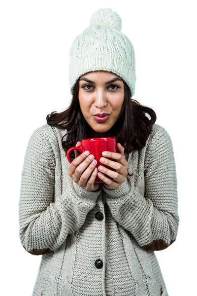 Festive brunette holding hot drink — Stock Photo, Image