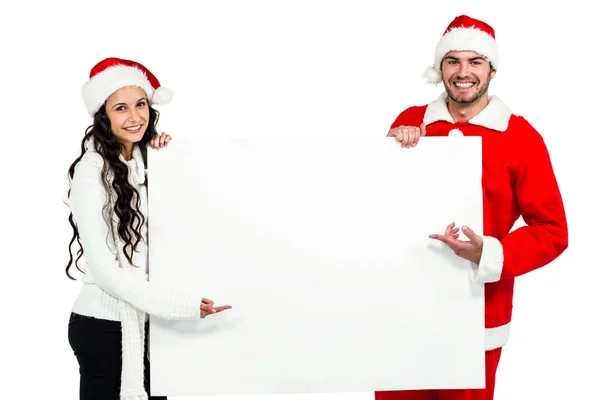 Festive couple showing a poster — Stock Photo, Image