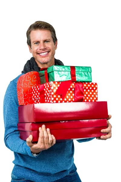 Man smiling and holding gifts — Stock Photo, Image