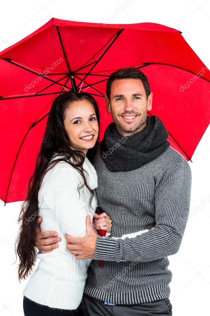 Smiling couple under umbrella — Stock Photo © Wavebreakmedia 91987350