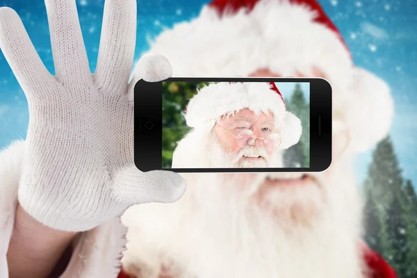 Santa segurando telefone celular — Fotografia de Stock
