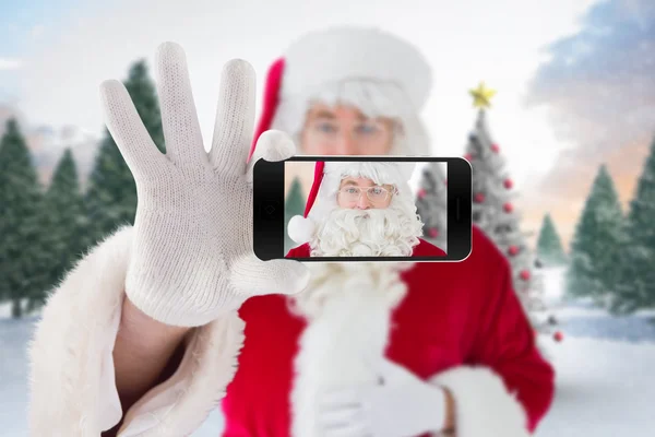 Santa segurando telefone celular — Fotografia de Stock