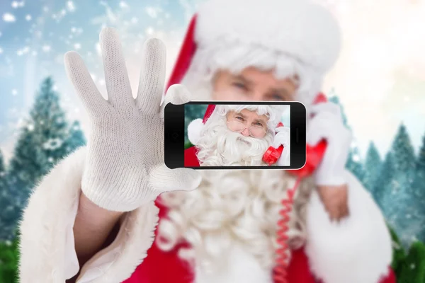 Santa holding mobile phone — Stock Photo, Image