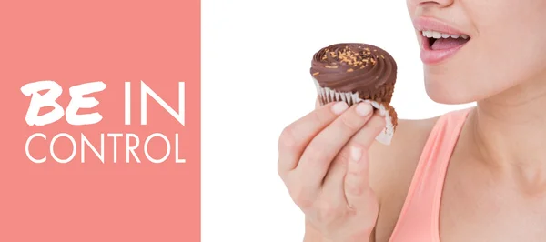 Brunette holding chocolate cupcake — Stock Photo, Image