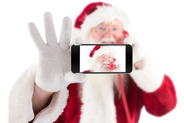 Santa holding mobile phone — Stock Photo, Image