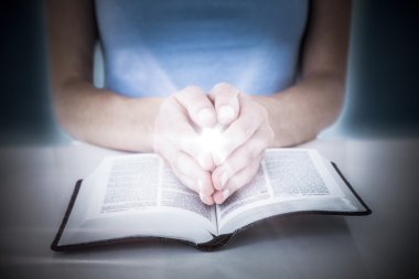 woman praying while reading bible clipart