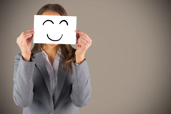 Composite image of businesswoman showing a card — Stock Photo, Image