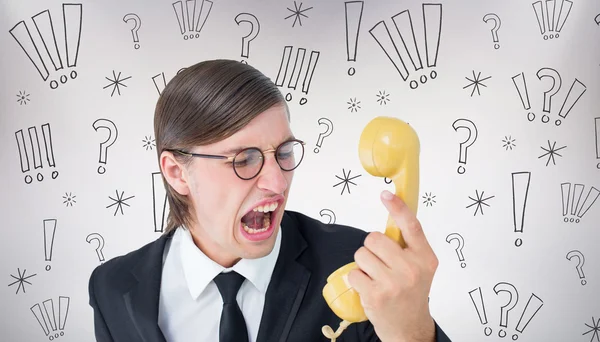 Geeky businessman shouting at retro phone — Stock Photo, Image