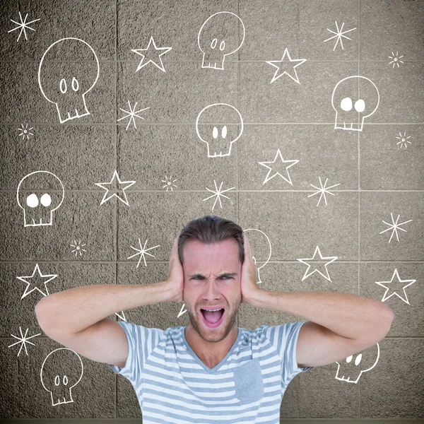 Handsome man screaming while covering ears — Stock Photo, Image