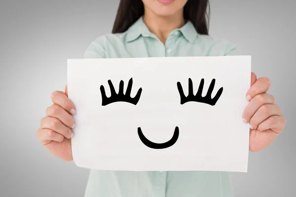 Composite image of brunette showing sign — Stock Photo, Image