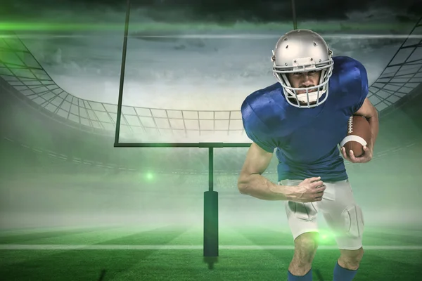 Portrait of american football player holding ball — Stock Photo, Image