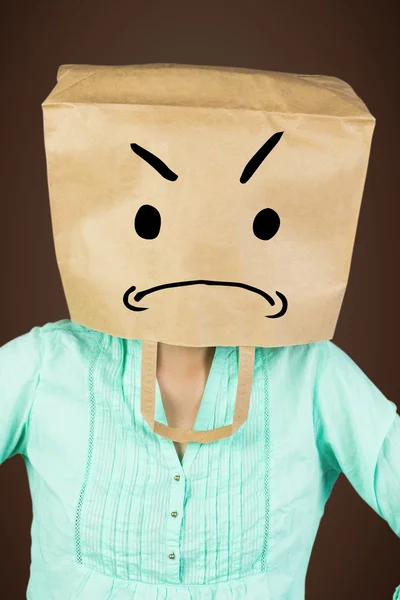 Woman with hands on hip and covering head with paper bag — Stock Photo, Image