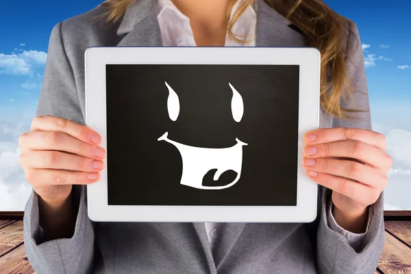 Businesswoman showing tablet against wooden planks — Stock Photo, Image