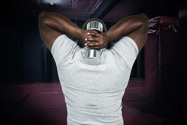 Fit man exercising with dumbbell — Stock Photo, Image