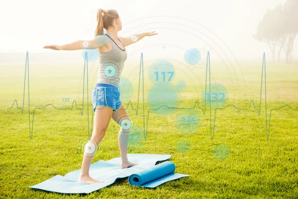 Sporty blonde doing yoga on exercise mat — Stock Photo, Image