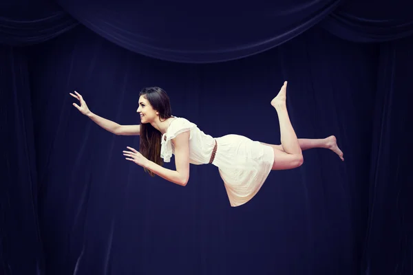 Girl in white dress floating in air — Stock Photo, Image