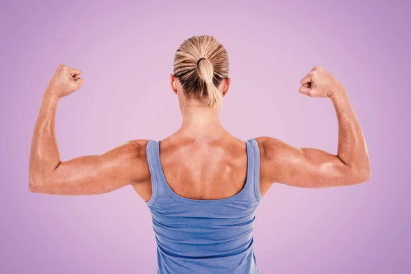 Rear view of woman flexing muscles — Stock Photo, Image