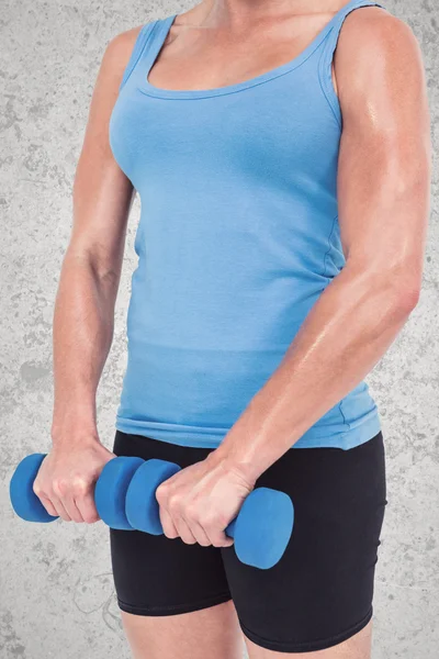 Muscular woman exercising with dumbbells — Stock Photo, Image