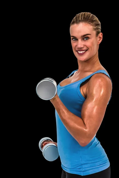 Muskulös kvinna tränar med hantlar — Stockfoto