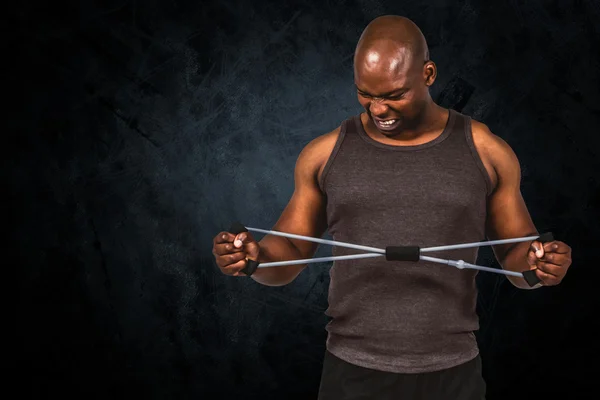 Fit man exercising with resistance band — Stock Photo, Image