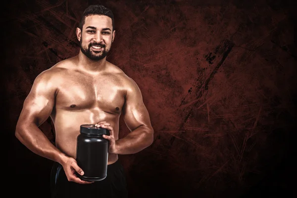 Hombre muscular con proteína en polvo —  Fotos de Stock