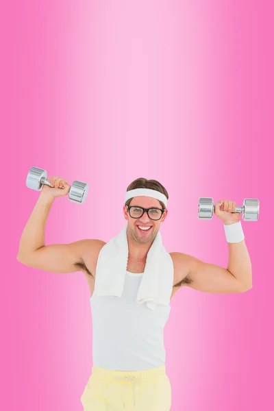 Geeky hipster lifting dumbbells in sportswear — Stock Photo, Image