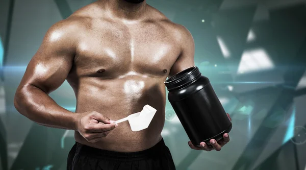 Muscular man with protein powder — Stock Photo, Image