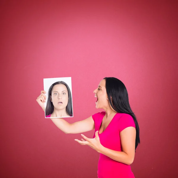 Woman shouting at picture of herself — Stock Photo, Image