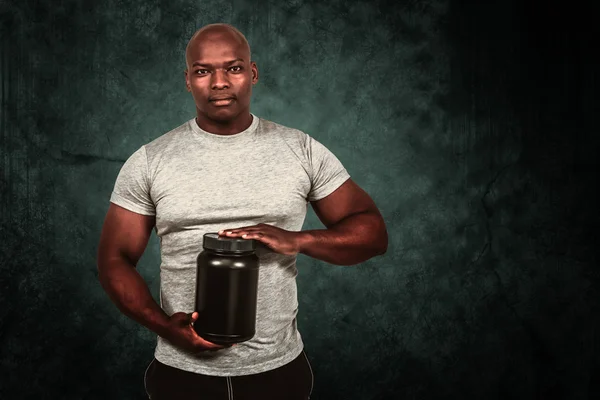 Fit man with protein powder — Stock Photo, Image