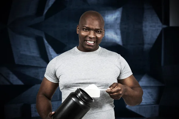 Fit man scooping protein powder — Stock Photo, Image