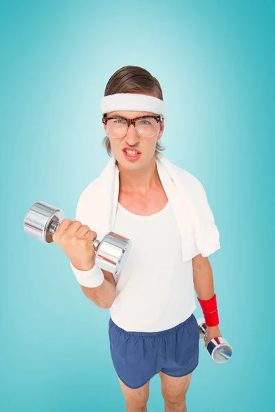 Geeky hipster lifting dumbbells in sportswear — Stock Photo, Image