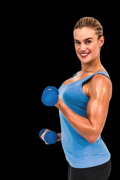 Muscular woman exercising with dumbbells — Stock Photo, Image