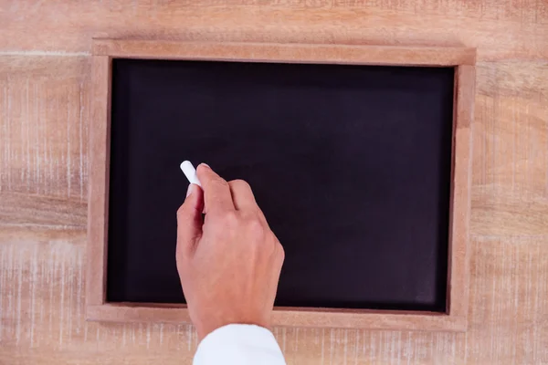 View of hand writing on blackboard — Stock Photo, Image