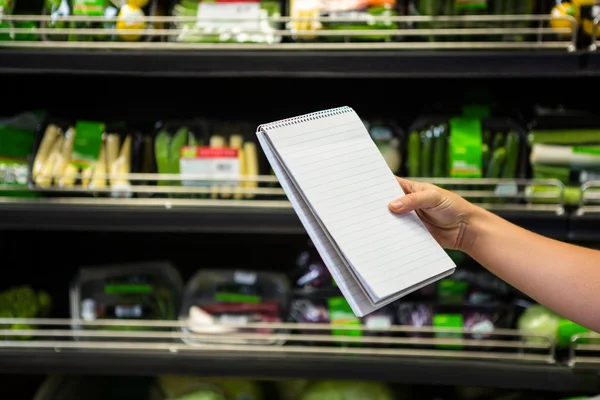 Womans hand holding a list — Stock Photo, Image