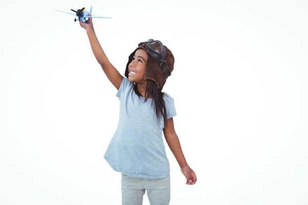 Smiling girl playing with toy airplane — Stock Photo, Image