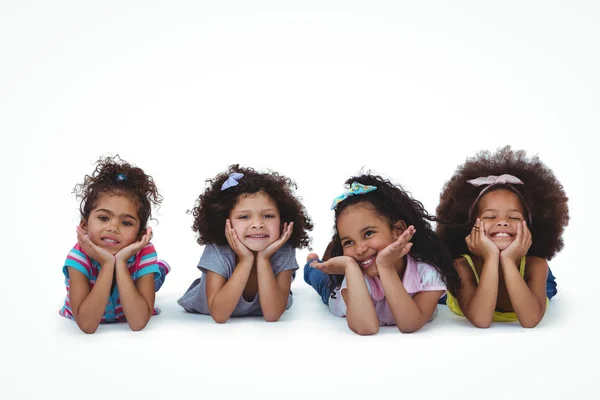 Cute girls laying on the floor with head on hands — Stock Photo, Image